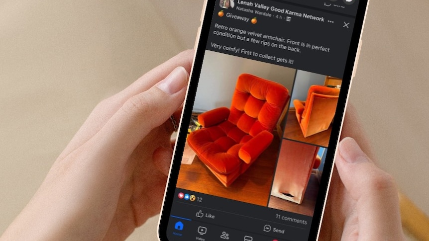A velvet orange chair photo on a mobile phone held in a white-person's hands.