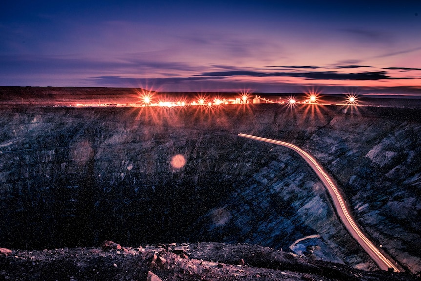 Open pit gold mine at sunset
