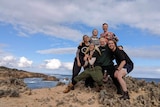 Patrick Lenton and friends pose at the beach.