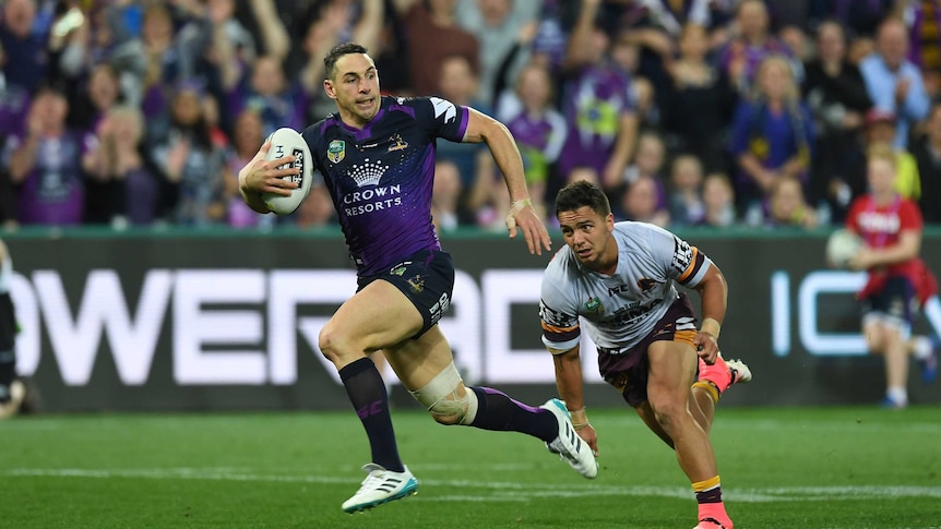 Billy Slater of the Storm (L) breaks past Kodi Nikorima of the Broncos before scoring a try.
