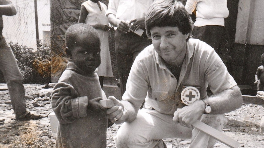 Bob Handby in Uganda handing soap to a child