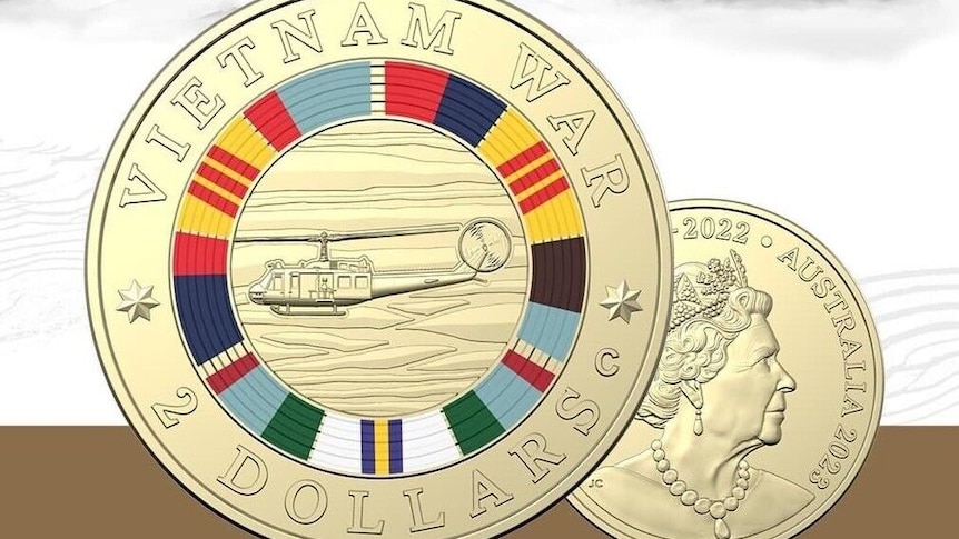 An Austrlain $2 coin has a picture of helicopter surrounded by bands of colour and the words "Vietnam war".