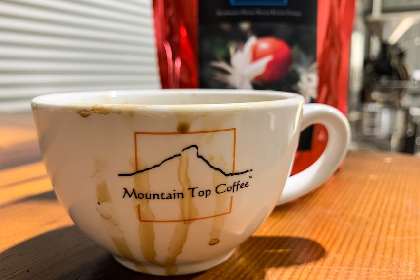 An espresso coffee cup with Mountain Top Coffee logo on the front.