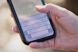 A close up of a phone keyboard in a language other than English.