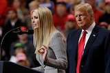 Ivanka Trump wears  raises one hand to gesticulate while giving speech as Donald Trump stands to her right.