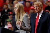 Ivanka Trump wears  raises one hand to gesticulate while giving speech as Donald Trump stands to her right.