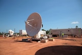 A satellite standing on the red earth of North-East Arnhem Land.