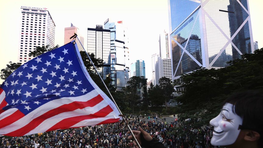 A protester waves an American flag during a rally in Hong Kong.