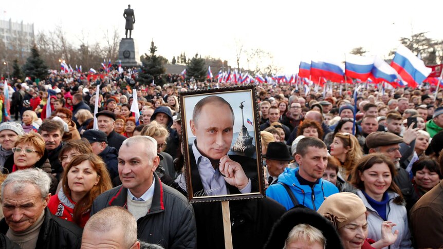 People attend a rally marking the fourth anniversary of Russia's annexation of Crimea