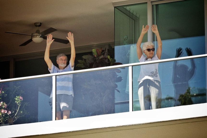 Elderly couple exercise on their balcony at Yeronga Retirement Village and Regis Aged Care in Brisbane.