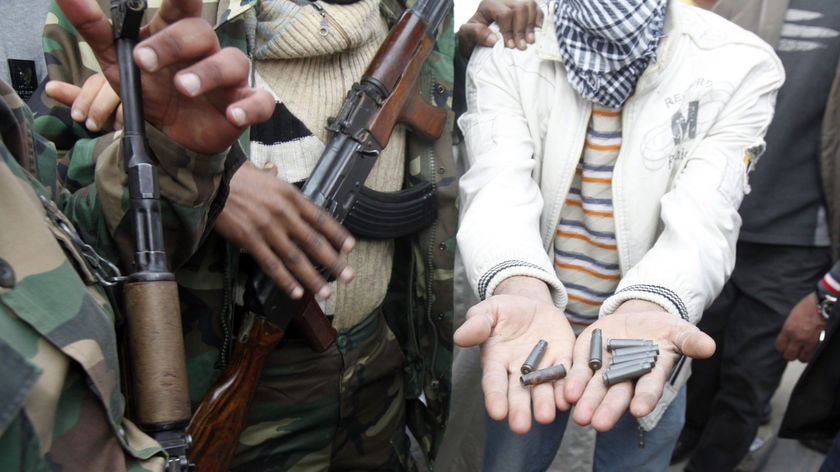 A Libyan protester shows spent ammunition casing