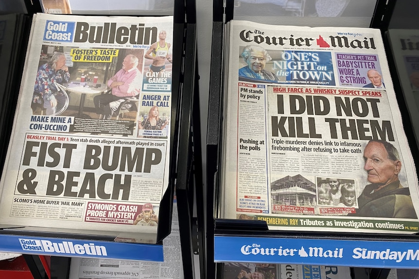 Newspaper stand with Gold Bulletin and Courier-Mail newspapers on display.