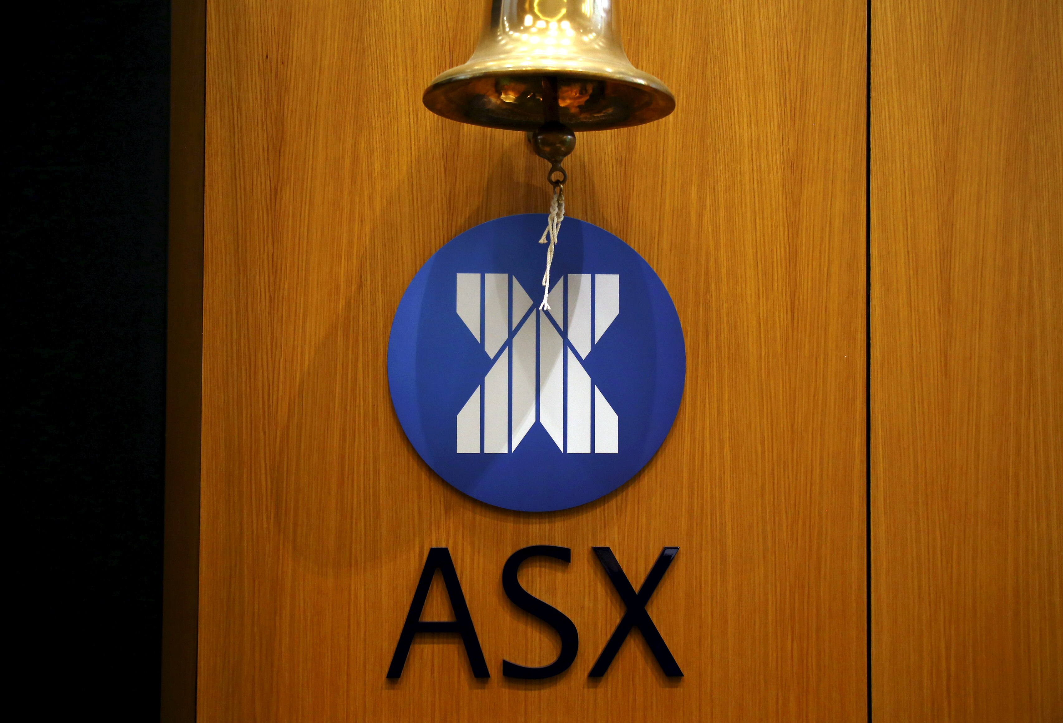 A bell hangs above an ASX logo. 