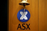 A bell hangs above an ASX logo. 