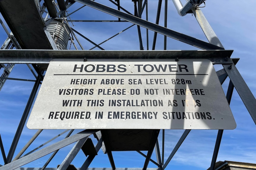 A sign on a metal tower that says Hobbs Tower.