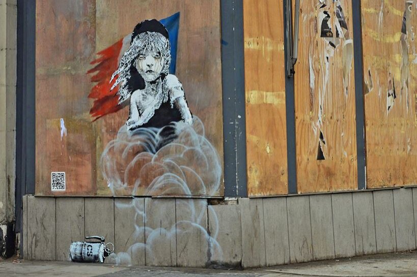 A mural by Banksy depicting Les Miserables character Cosette engulfed by clouds of gas.