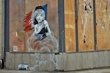 A mural by Banksy depicting "Les Miserables" character Cosette engulfed by clouds of gas.