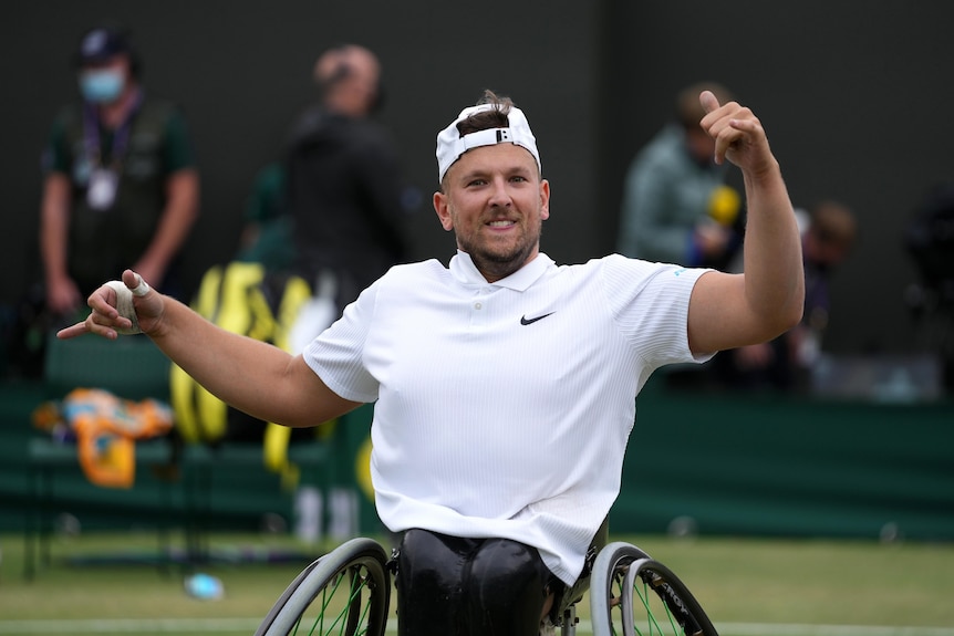 Australia's Dylan Alcott gestures to the crowd in celebration after winning the quad wheelchair singles title at Wimbledon.