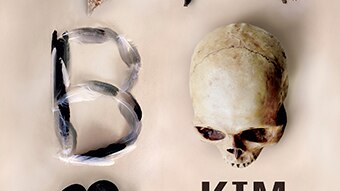 Book cover with the word 'taboo' spelt out with a variety of items including pebbles, twigs and a skull.