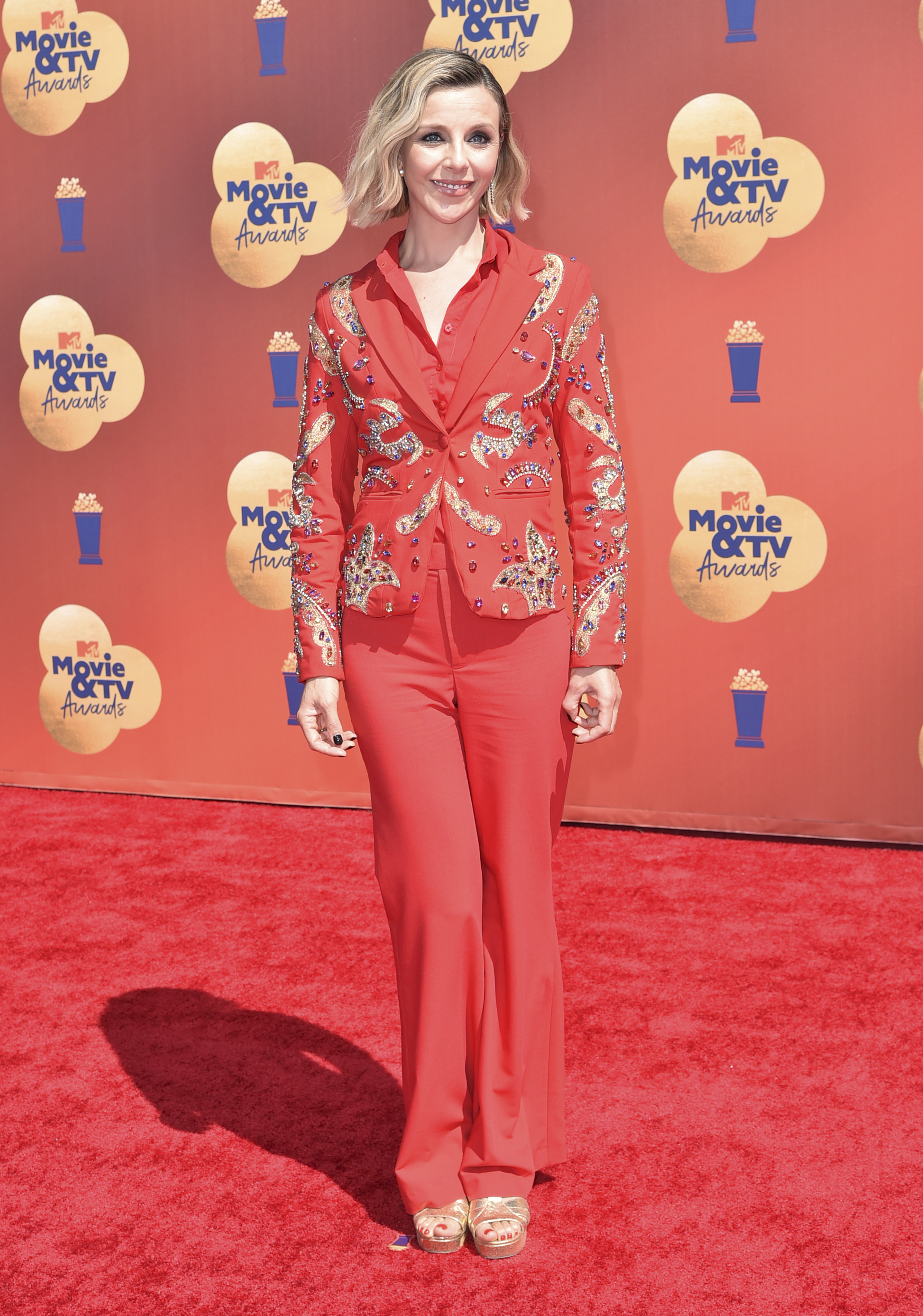Sophia poses on the red carpet in a red tuxedo. 