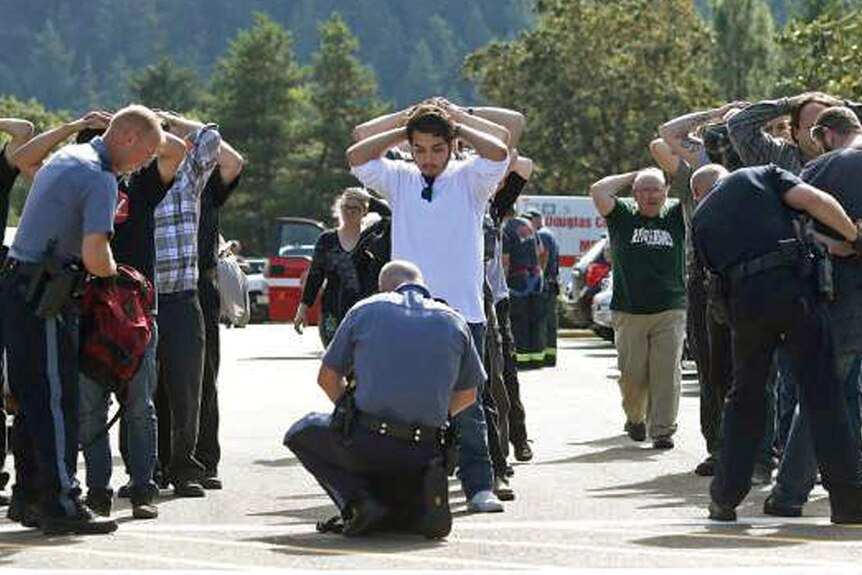 Police officers search students outside Umpqua Community College