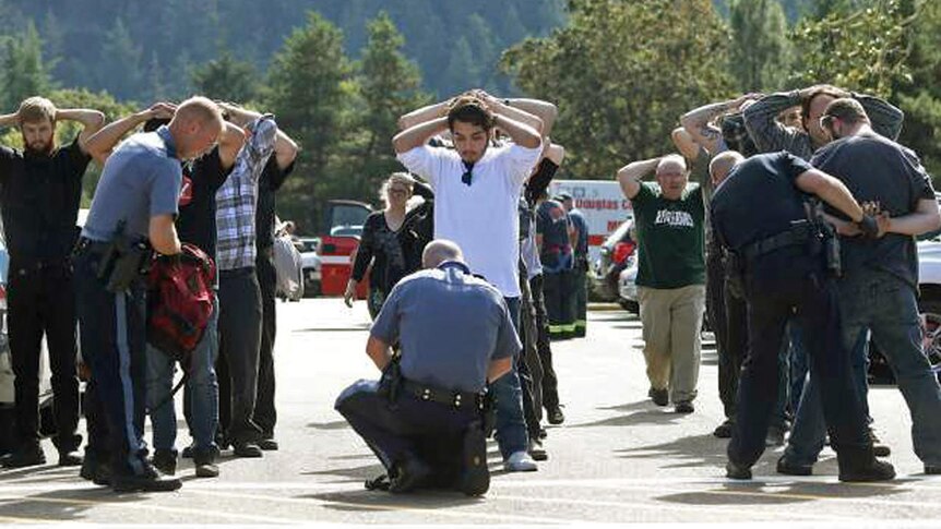 Police officers search students outside Umpqua Community College