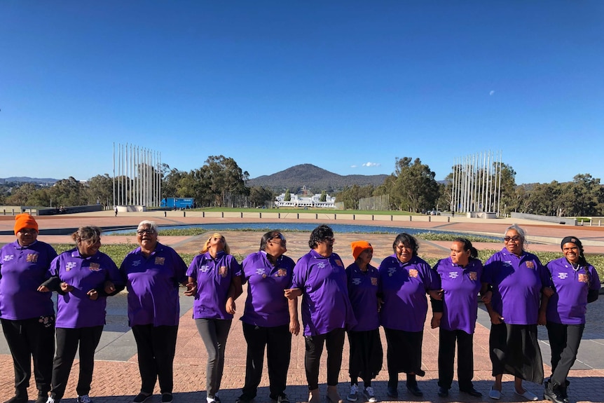 The Tangentyere Women's Family Safety Group pose for a photo.