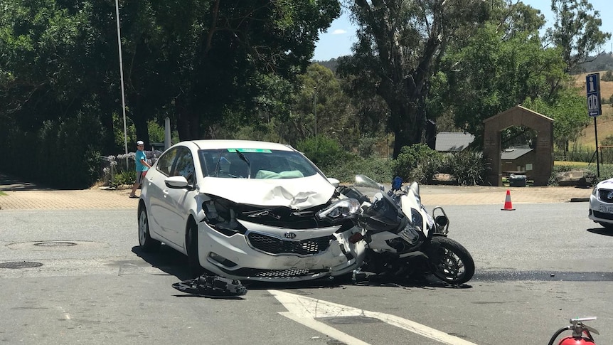 Aftermath of a collision between a car and a police motorbike.