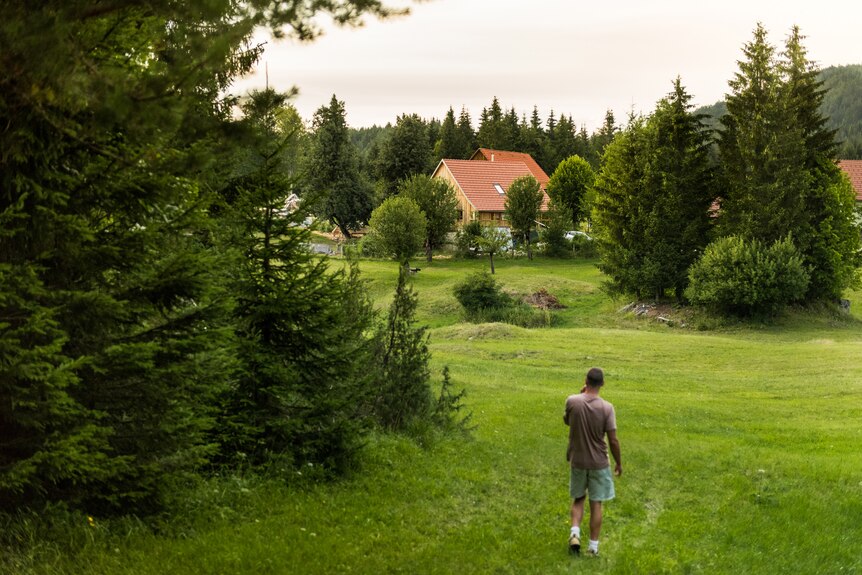 Aljaž Celarc walks down the hill towards their home