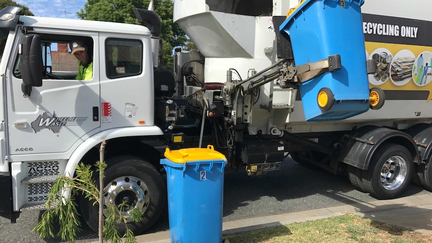 A Wheelie Waste truck picks up recycling bins in Shepparton.