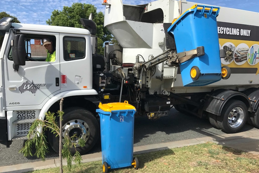 A Wheelie Waste truck picks up recycling bins in Shepparton.