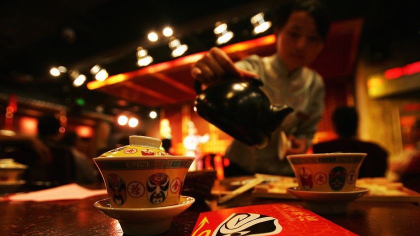 A waitress serves tea at the Lao She Teahouse in Beijing