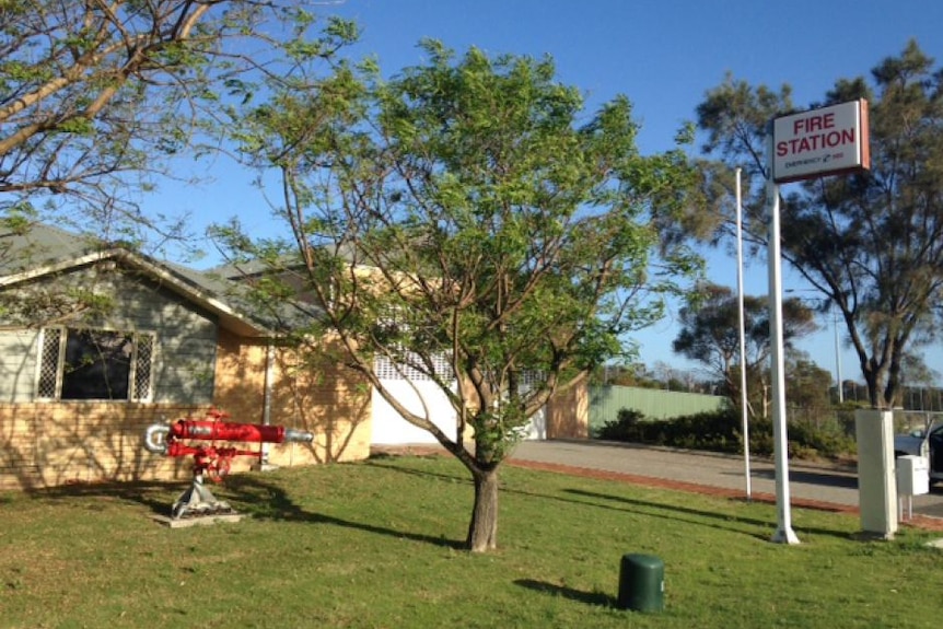 A wide shot of an old fire station in daytime.