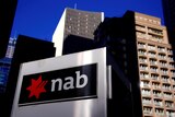 NAB's headquarters in Sydney with bank's logo in foreground.