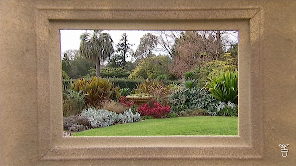 View of a garden through a picture frame.