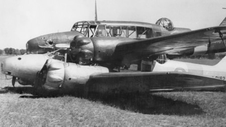 Black and white photo of two planes on top of each other.