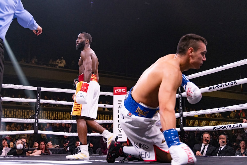 Tim Tszyu looks on crouching on one knee as Terrell Gausha walks away