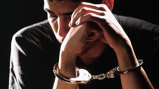 Male youth in handcuffs