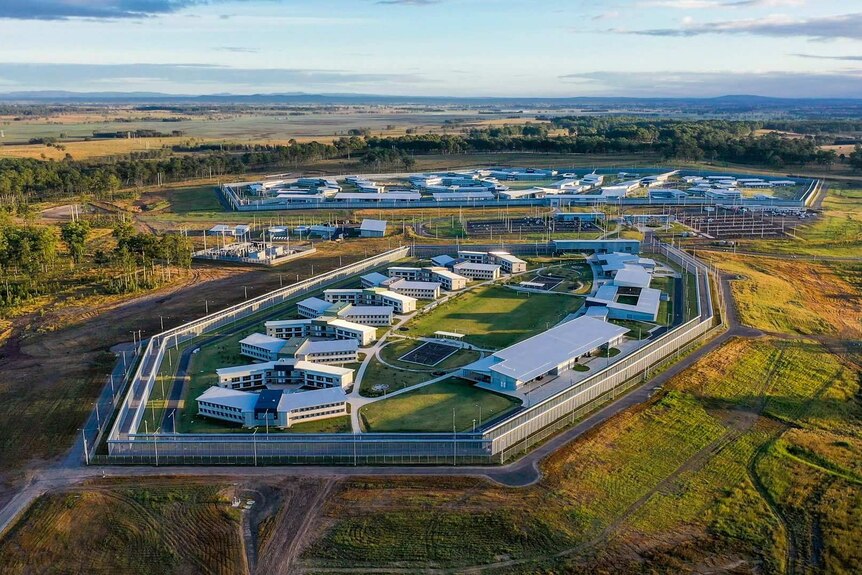 Aerial shot of a newly-built prison surrounded by pastoral land.