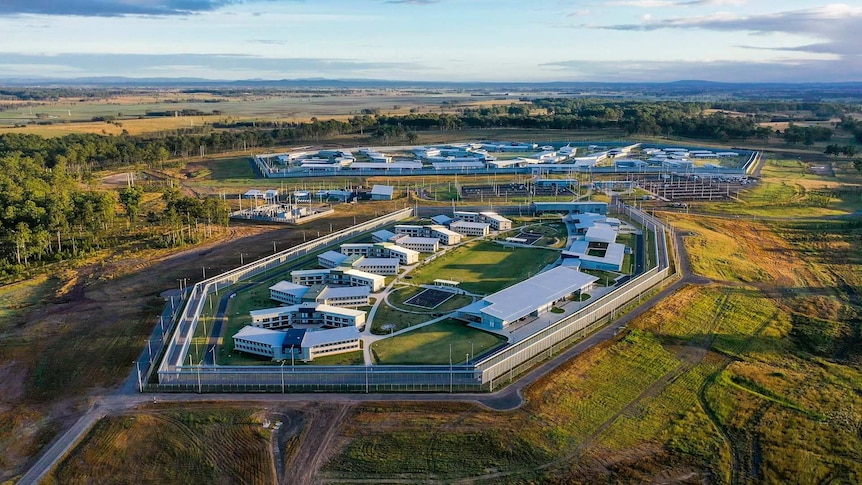 Aerial shot of a newly-built prison surrounded by pastoral land.