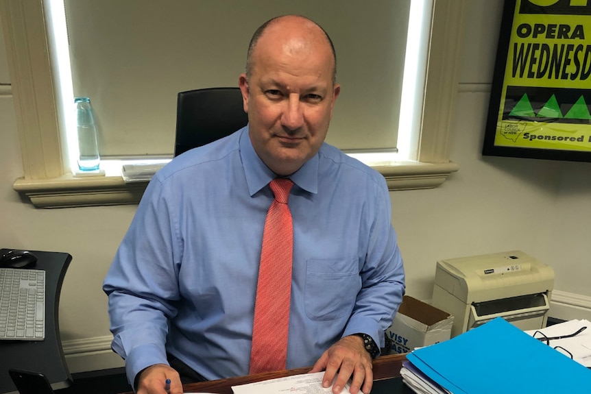 A man sits at a desk