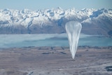 A Project Loon balloon floats past snow-capped mountains in New Zealand
