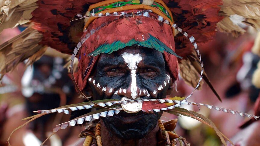 Man in traditional headdress and face paint at the 2016 Goroka Show in Papua New Guinea