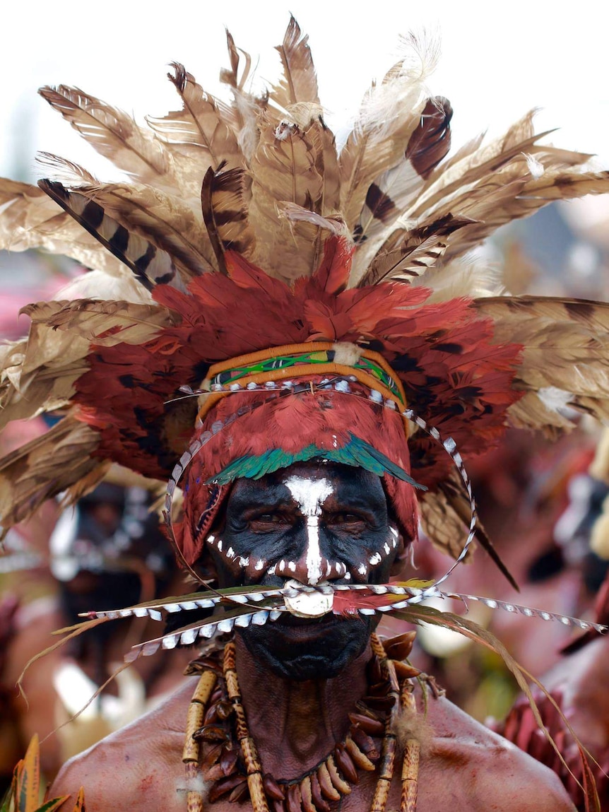 Man in traditional headdress and face paint at the 2016 Goroka Show in Papua New Guinea
