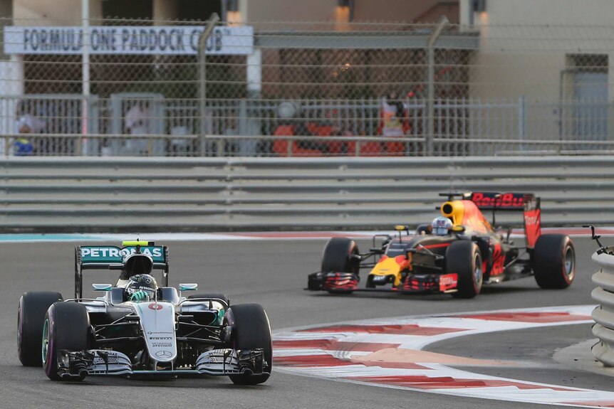 Maiden title ... Nico Rosberg (L) steers his car through a corner ahead of Daniel Ricciardo