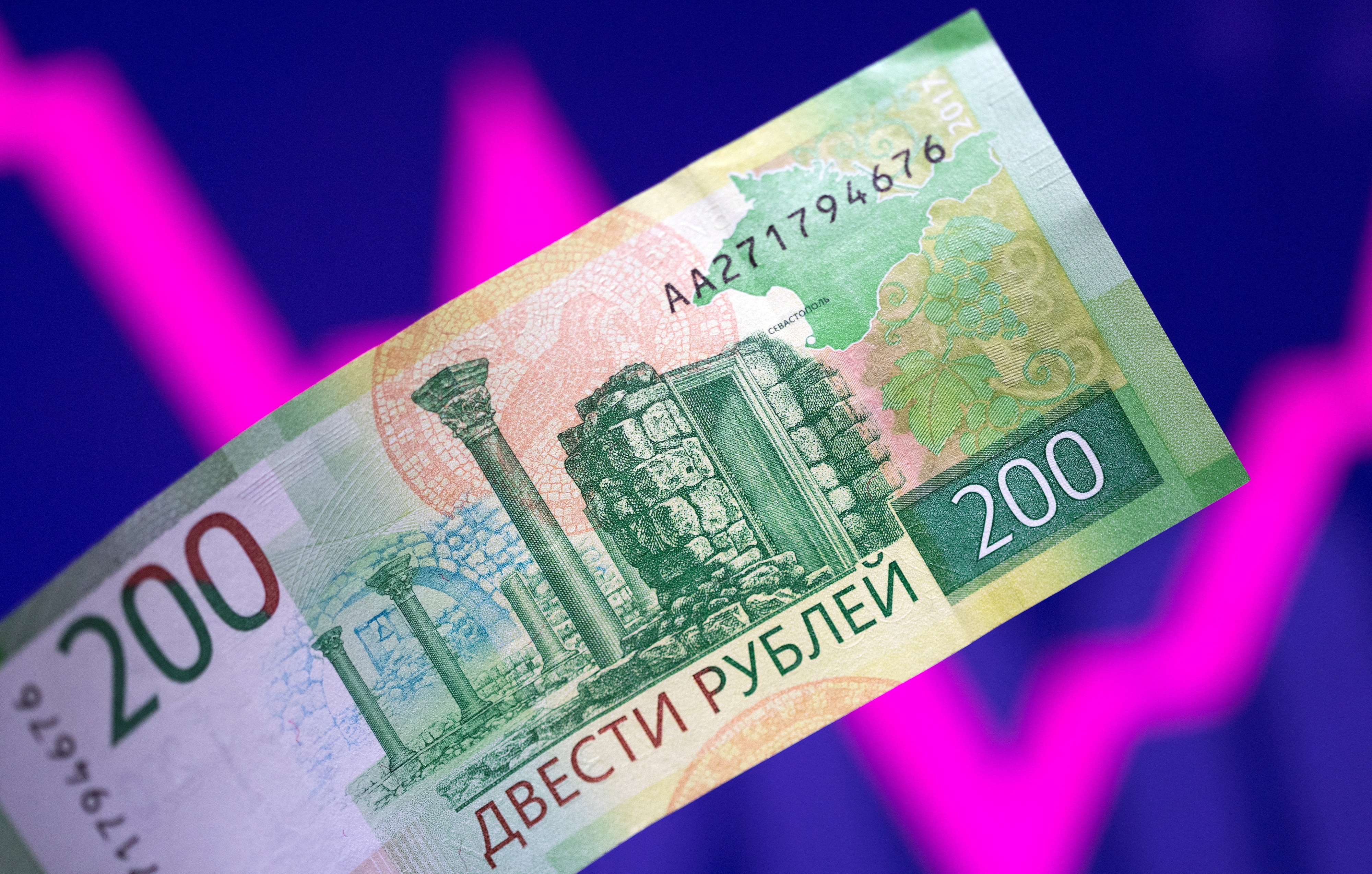 Illustration shows a Russian rouble banknote and a descending and rising stock graph.