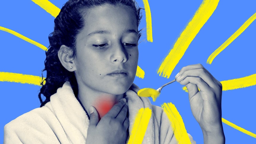 Child with red throat about to take a spoonful of honey which may help with her cough.