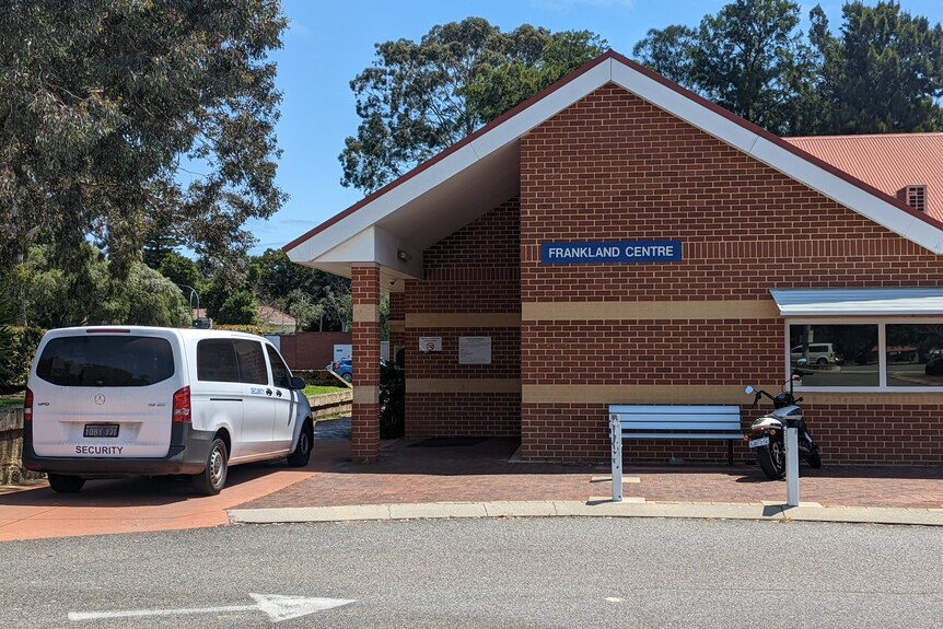 The brick exterior of the Frankland Centre with a van labelled "security" parked outside.