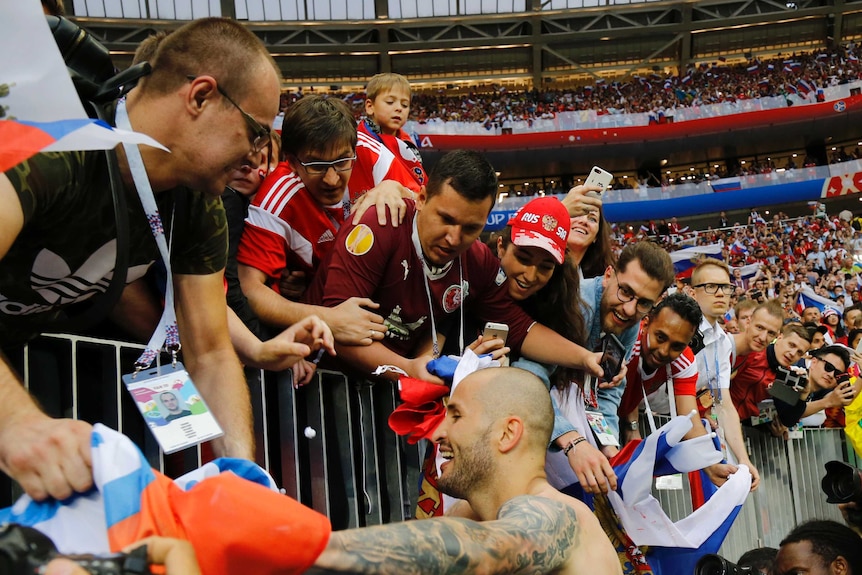 Fyodor Kudryashov celebrates with Russia fans after win over Spain