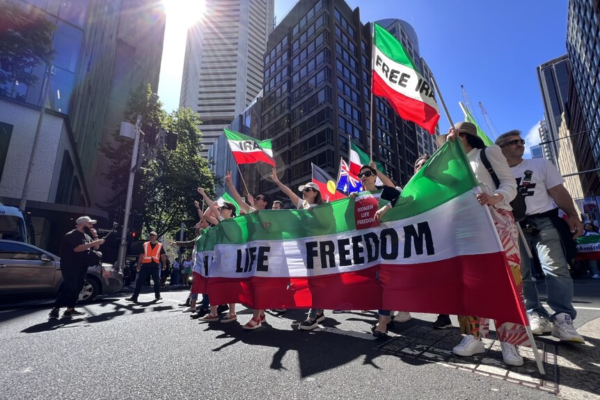 Protesters with messages of freedom on colours of Iranian flag
